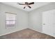 Bright bedroom featuring a window, ceiling fan, and carpet flooring at 6330 W Constance Way, Laveen, AZ 85339