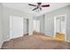 Spacious bedroom with a ceiling fan, closet, and carpet flooring at 6330 W Constance Way, Laveen, AZ 85339