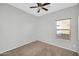 Bedroom features carpet flooring, a ceiling fan, and a window for natural lighting at 6330 W Constance Way, Laveen, AZ 85339