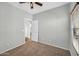 Bedroom with neutral walls, carpet, and ceiling fan; door to another room shown at 6330 W Constance Way, Laveen, AZ 85339