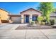 Charming single-story home featuring a manicured front yard, a covered entry, and a two-car garage at 6330 W Constance Way, Laveen, AZ 85339