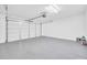 Clean, spacious garage with gray epoxy flooring and an automatic door opener at 6330 W Constance Way, Laveen, AZ 85339
