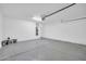 Spacious garage with painted concrete flooring, water heater, and garage door opener at 6330 W Constance Way, Laveen, AZ 85339