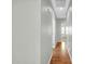Hallway with view of bedroom with neutral paint and flooring throughout at 6330 W Constance Way, Laveen, AZ 85339