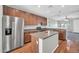 Modern kitchen featuring stainless steel appliances, spacious countertops, a kitchen island, and wood-look floors at 6330 W Constance Way, Laveen, AZ 85339