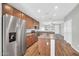 Modern kitchen featuring stainless steel appliances, spacious countertops, a kitchen island, and wood-look floors at 6330 W Constance Way, Laveen, AZ 85339