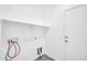 Clean and functional laundry room features storage shelves and tiled flooring at 6330 W Constance Way, Laveen, AZ 85339
