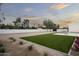Expansive backyard showcasing artificial turf, gravel, and a sparkling pool at 7001 E Joan De Arc Ave, Scottsdale, AZ 85254