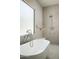 A contemporary style bathroom features a tub with chrome fixtures, a shower, and large windows at 7001 E Joan De Arc Ave, Scottsdale, AZ 85254