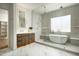 Modern bathroom featuring a freestanding tub, a glass-enclosed shower, and stylish vanity with illuminated mirrors at 7001 E Joan De Arc Ave, Scottsdale, AZ 85254
