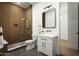 Bathroom featuring wood paneled shower, matte black plumbing fixtures, and a white vanity cabinet at 7001 E Joan De Arc Ave, Scottsdale, AZ 85254