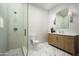 Modern bathroom with glass shower, toilet, modern vanity, quartz countertops, and marble tile floor at 7001 E Joan De Arc Ave, Scottsdale, AZ 85254