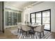 Bright dining room featuring modern lighting, a wine cellar, and large windows offering scenic views at 7001 E Joan De Arc Ave, Scottsdale, AZ 85254