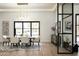 Elegant dining room features a modern chandelier, neutral decor, and large windows for natural light at 7001 E Joan De Arc Ave, Scottsdale, AZ 85254