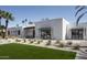 Modern home featuring a white brick facade, dark-framed windows, and a minimalist landscape design with desert plants at 7001 E Joan De Arc Ave, Scottsdale, AZ 85254