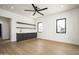 Flex space featuring dark cabinets, wine bar, open floating shelves, undermount lighting, and natural wood floors at 7001 E Joan De Arc Ave, Scottsdale, AZ 85254