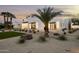 Wide shot of the house exterior with desert landscaping, white brick and black trim modern design at 7001 E Joan De Arc Ave, Scottsdale, AZ 85254