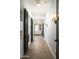 Hallway features modern lighting, accent wall, herringbone wood floors, and views to other rooms at 7001 E Joan De Arc Ave, Scottsdale, AZ 85254