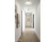 Hallway features modern lighting, neutral walls, herringbone wood floors, and contemporary art at 7001 E Joan De Arc Ave, Scottsdale, AZ 85254