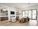 Stylish living room boasts a fireplace, built-in shelving, and an open layout with wood flooring at 7001 E Joan De Arc Ave, Scottsdale, AZ 85254