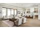 Bright living room showcases modern decor, wood floors, and seamless flow to the contemporary kitchen at 7001 E Joan De Arc Ave, Scottsdale, AZ 85254