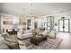 Spacious living room featuring a modern chandelier, sleek kitchen, and open layout perfect for entertaining at 7001 E Joan De Arc Ave, Scottsdale, AZ 85254