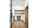 Convenient pantry includes shelving, ample storage, and sleek countertops, perfect for organizing supplies at 7001 E Joan De Arc Ave, Scottsdale, AZ 85254