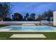 Beautiful backyard pool and spa area with black and white tile accents at 7001 E Joan De Arc Ave, Scottsdale, AZ 85254