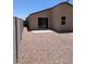 Low maintenance backyard with a small patio, rock landscaping and privacy block wall at 7218 E Grouse Ct, San Tan Valley, AZ 85143