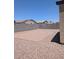 Low maintenance backyard featuring gravel and block walls with a view of neighborhood homes at 7218 E Grouse Ct, San Tan Valley, AZ 85143