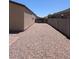 Low maintenance backyard featuring gravel and block walls with a view of neighborhood homes at 7218 E Grouse Ct, San Tan Valley, AZ 85143