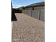 Backyard featuring gravel and a view of a tall fence at 7218 E Grouse Ct, San Tan Valley, AZ 85143