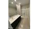 Bathroom with dual sinks, tile floors, and a glass enclosed shower at 7218 E Grouse Ct, San Tan Valley, AZ 85143