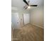 Bedroom with neutral carpeting featuring a ceiling fan and closet with sliding doors, offering storage and space at 7218 E Grouse Ct, San Tan Valley, AZ 85143