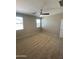 Neutral carpeted bedroom with a ceiling fan and two windows at 7218 E Grouse Ct, San Tan Valley, AZ 85143