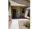 Close up of the front entry way of a tan single-story home with desert landscaping at 7218 E Grouse Ct, San Tan Valley, AZ 85143