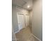 Hallway with tile flooring leading to two white doors, showcasing clean lines and neutral tones at 7218 E Grouse Ct, San Tan Valley, AZ 85143