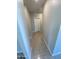 Hallway with tile flooring leading to a white door, showcasing clean lines and neutral tones at 7218 E Grouse Ct, San Tan Valley, AZ 85143