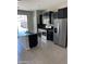 Modern kitchen with stainless steel appliances, dark cabinets and tile backsplash at 7218 E Grouse Ct, San Tan Valley, AZ 85143