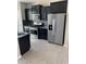 A modern kitchen featuring stainless steel appliances, dark cabinets and a tile backsplash at 7218 E Grouse Ct, San Tan Valley, AZ 85143