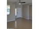 Open-concept living room with tile floors, a ceiling fan, and plenty of natural light at 7218 E Grouse Ct, San Tan Valley, AZ 85143