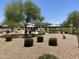 Community playground and picnic area, featuring a covered shelter and mature trees offering shade on a sunny day at 7218 E Grouse Ct, San Tan Valley, AZ 85143