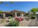 Backyard patio area surrounded by desert landscaping and flowering bushes at 7438 E Visao Dr, Scottsdale, AZ 85266