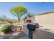 Outdoor space includes a built-in grill, desert landscaping, and block wall for added privacy at 7438 E Visao Dr, Scottsdale, AZ 85266