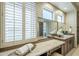 Bathroom vanity area features wood cabinets, an undermount sink, and a large window with shutters at 7438 E Visao Dr, Scottsdale, AZ 85266