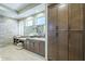 Bathroom with double sinks, marble countertop, and custom storage cabinets at 7438 E Visao Dr, Scottsdale, AZ 85266