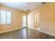 Bedroom with light orange walls, tile floors, and a door leading to the backyard at 7438 E Visao Dr, Scottsdale, AZ 85266