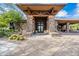 Clubhouse exterior features stone accents, timber beams, and desert landscaping at 7438 E Visao Dr, Scottsdale, AZ 85266