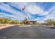 The community entrance with an American flag, mature trees, and desert landscaping at 7438 E Visao Dr, Scottsdale, AZ 85266