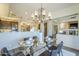 Chic dining room showcases a glass table, modern chandelier, and seamless flow to the living areas at 7438 E Visao Dr, Scottsdale, AZ 85266